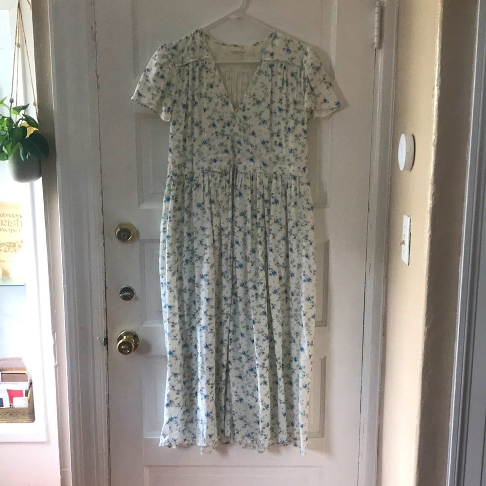 The Dawn Dress, white with small blue flowers.